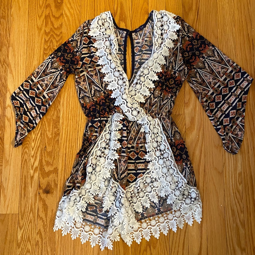 UK2LA short romper. Quarter length sleeves. Multi-colored with fringe.